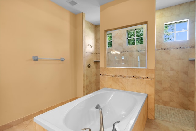 bathroom featuring separate shower and tub and tile patterned flooring