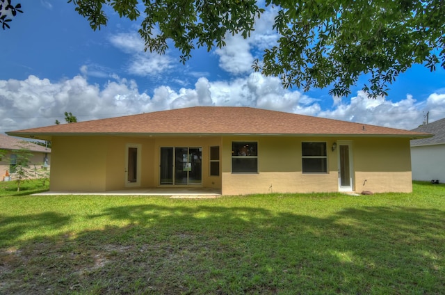 back of house featuring a patio area and a yard