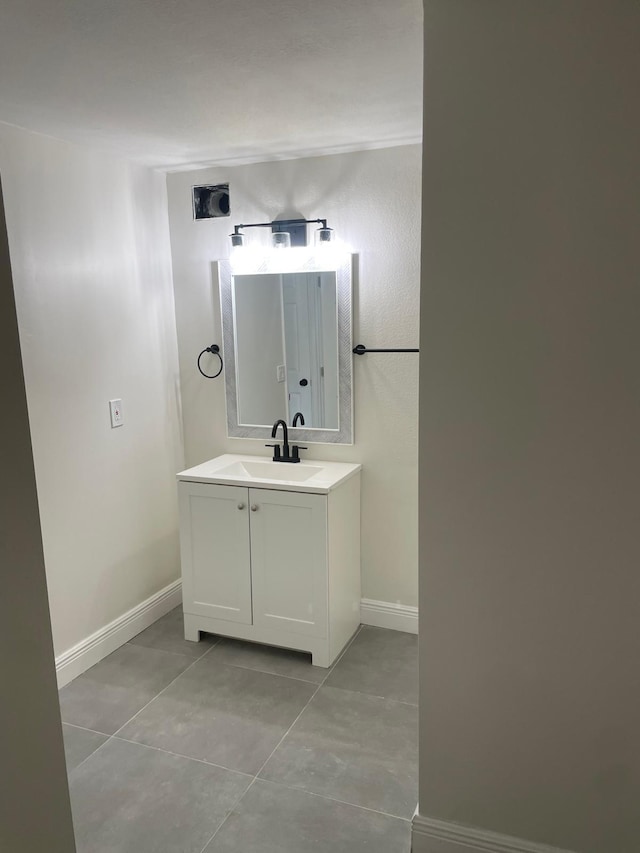 bathroom with tile patterned flooring and vanity