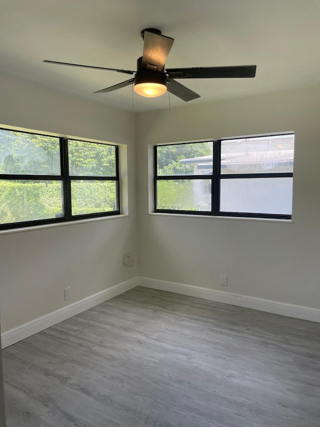 spare room with light wood-type flooring and ceiling fan