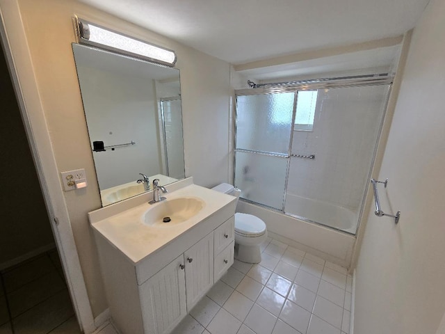 full bathroom featuring vanity, toilet, tile patterned flooring, and bath / shower combo with glass door