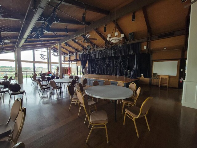 dining room with high vaulted ceiling, wood-type flooring, and beam ceiling