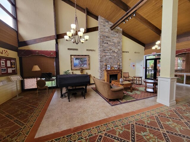 living room with high vaulted ceiling, a fireplace, a chandelier, and wooden ceiling