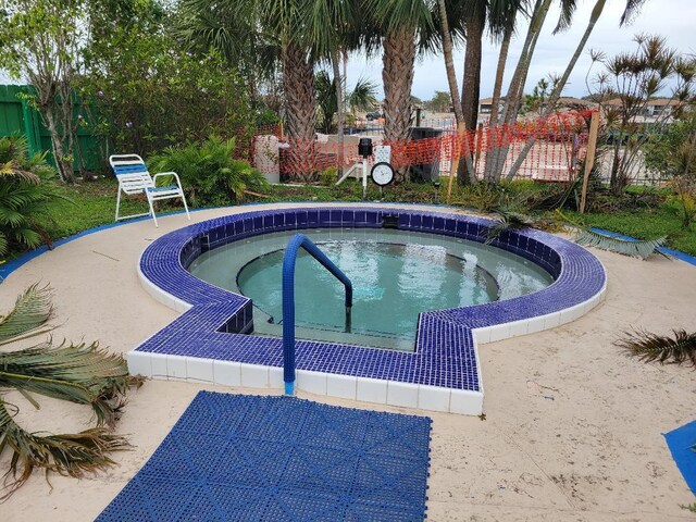 view of pool with a community hot tub