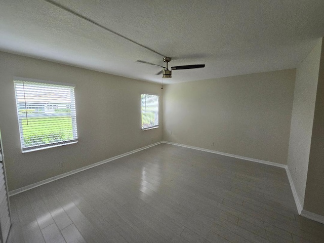 unfurnished room with a wealth of natural light and hardwood / wood-style flooring