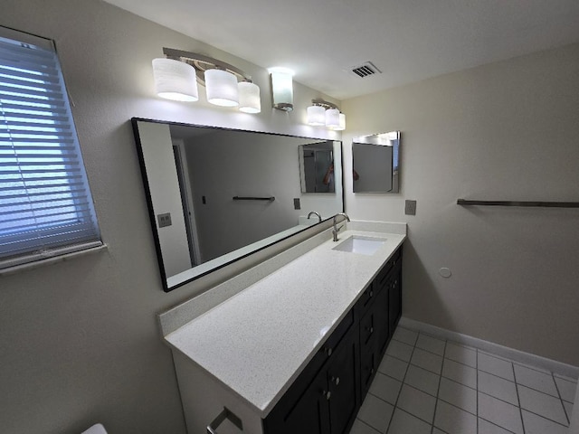 bathroom featuring tile patterned flooring and vanity