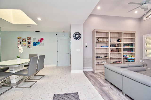 living room with light hardwood / wood-style flooring and ceiling fan