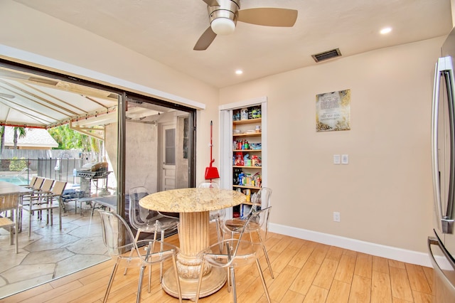 dining room featuring ceiling fan and light wood-type flooring