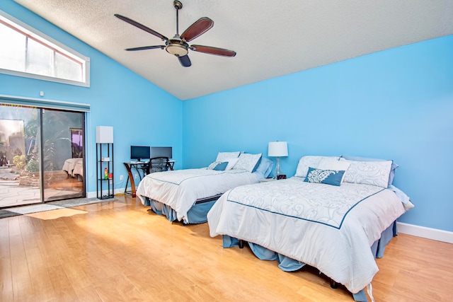 bedroom featuring a textured ceiling, access to exterior, ceiling fan, and light hardwood / wood-style floors