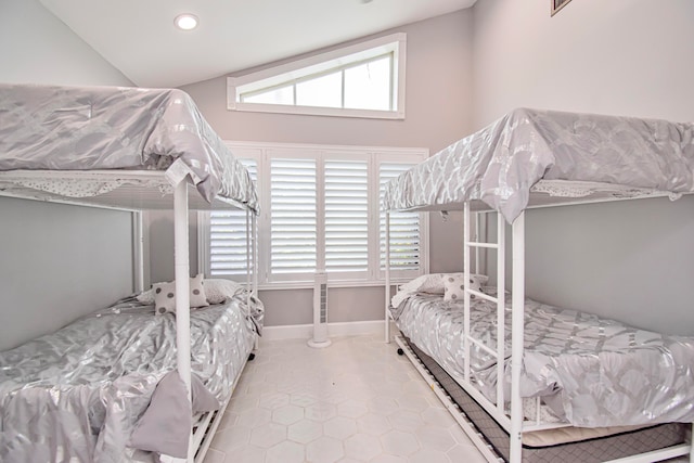 tiled bedroom featuring lofted ceiling