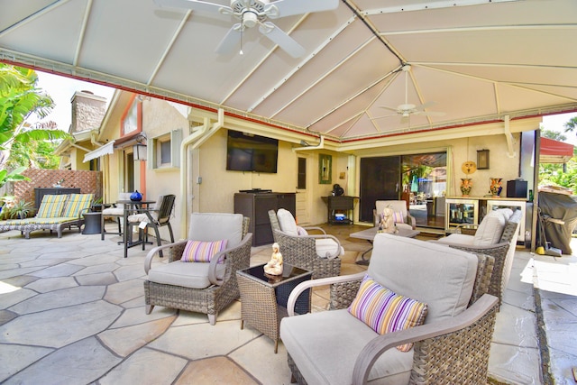 view of patio with an outdoor living space and ceiling fan