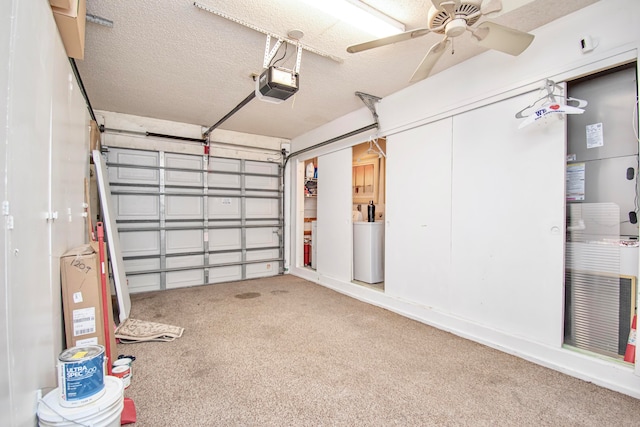 garage featuring a garage door opener, ceiling fan, and washer / clothes dryer