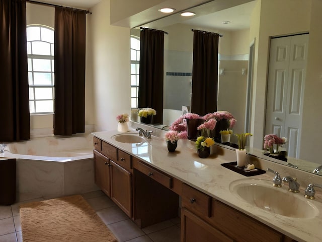 bathroom featuring vanity, plus walk in shower, and tile patterned flooring