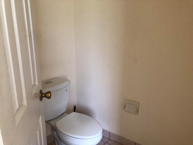 bathroom with tile patterned flooring and toilet