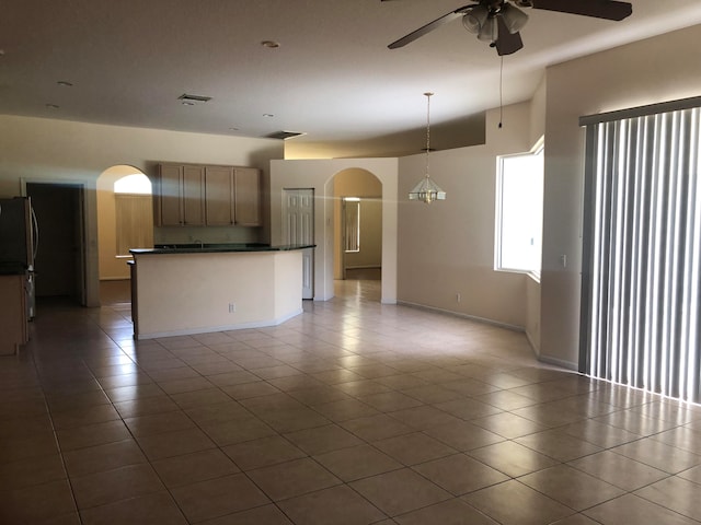 interior space with ceiling fan