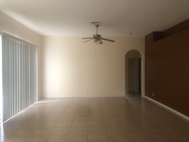 spare room with tile patterned flooring and ceiling fan