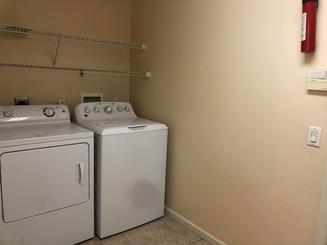 laundry room with light tile patterned floors and separate washer and dryer