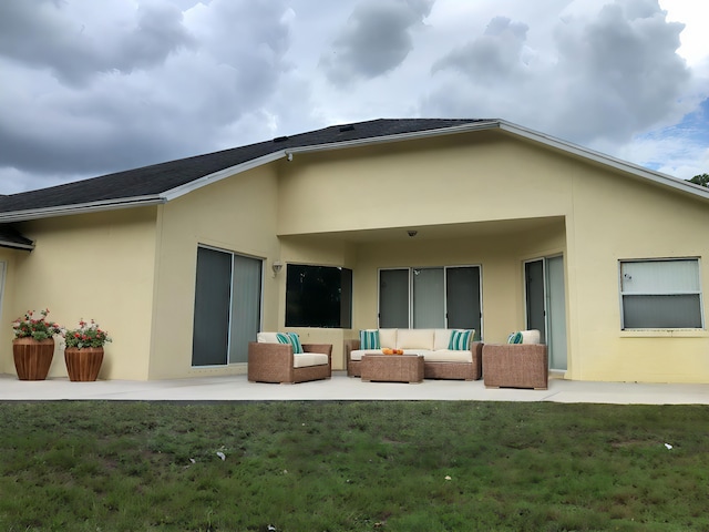 back of house with a yard, a patio area, and an outdoor hangout area