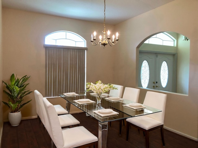 dining room featuring dark wood-type flooring and a chandelier