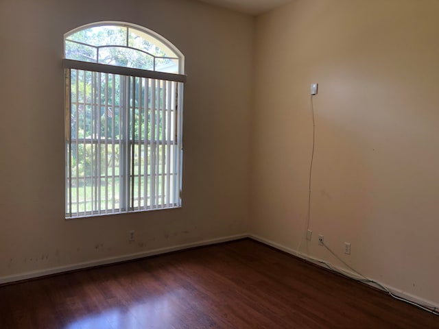 empty room with dark hardwood / wood-style floors