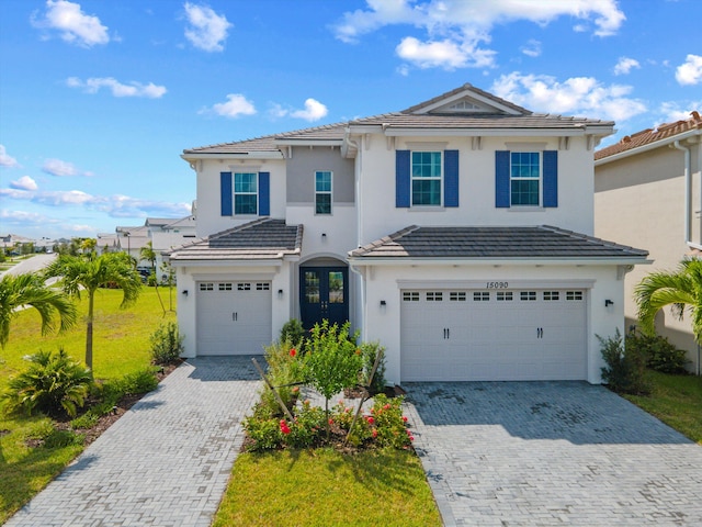 front facade with a garage and a front lawn