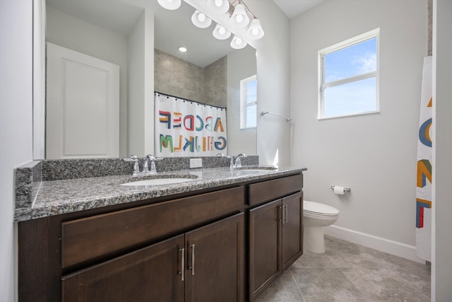 bathroom with curtained shower, vanity, and toilet