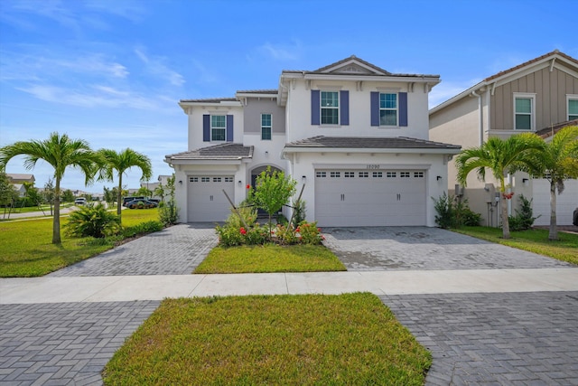 view of front facade with a garage and a front lawn