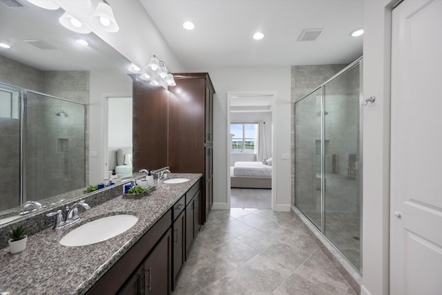 bathroom featuring tile patterned flooring, walk in shower, and vanity