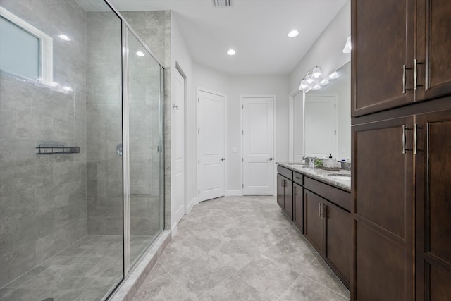 bathroom featuring an enclosed shower and vanity