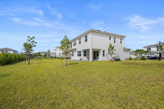 rear view of house with a yard