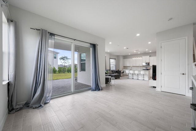 unfurnished living room featuring light hardwood / wood-style floors