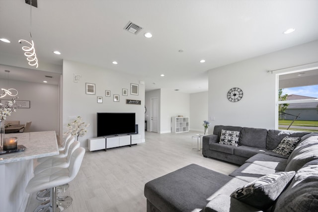 living room with light hardwood / wood-style flooring