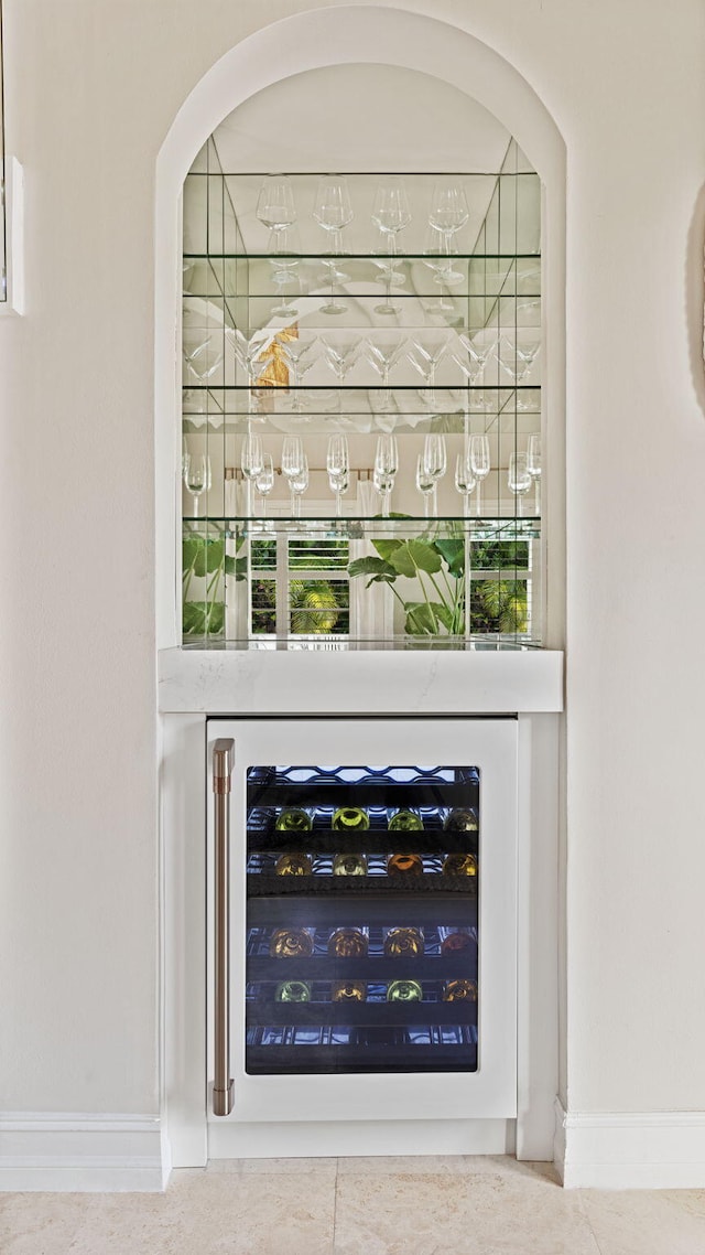 bar with plenty of natural light and wine cooler