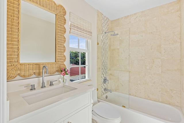 full bathroom with tiled shower / bath, toilet, and vanity