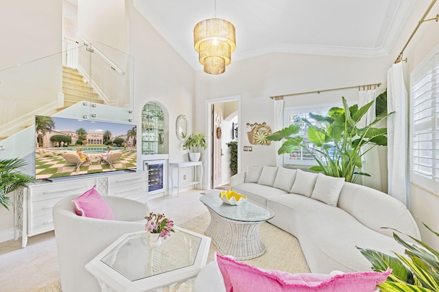 tiled living room with crown molding, high vaulted ceiling, and an inviting chandelier