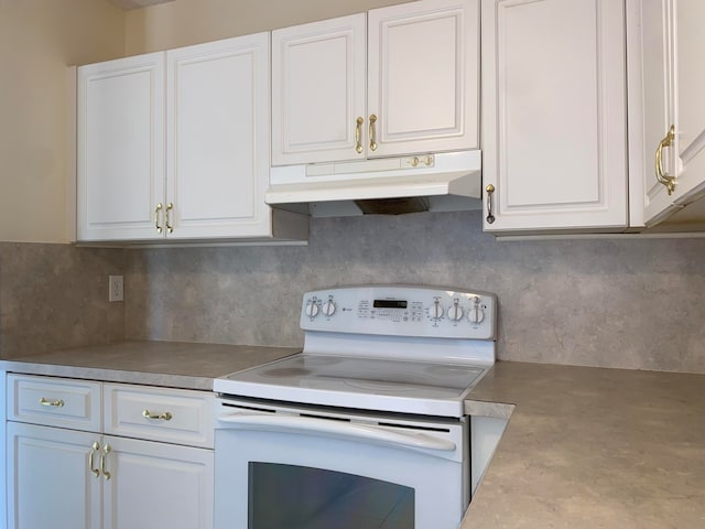 kitchen with white electric range, white cabinets, and concrete flooring