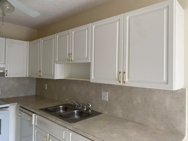 kitchen featuring white appliances, sink, white cabinetry, and ceiling fan