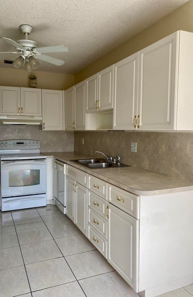 kitchen featuring white appliances, a textured ceiling, sink, ceiling fan, and white cabinets