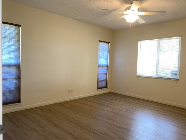 unfurnished room with a textured ceiling, hardwood / wood-style floors, and ceiling fan