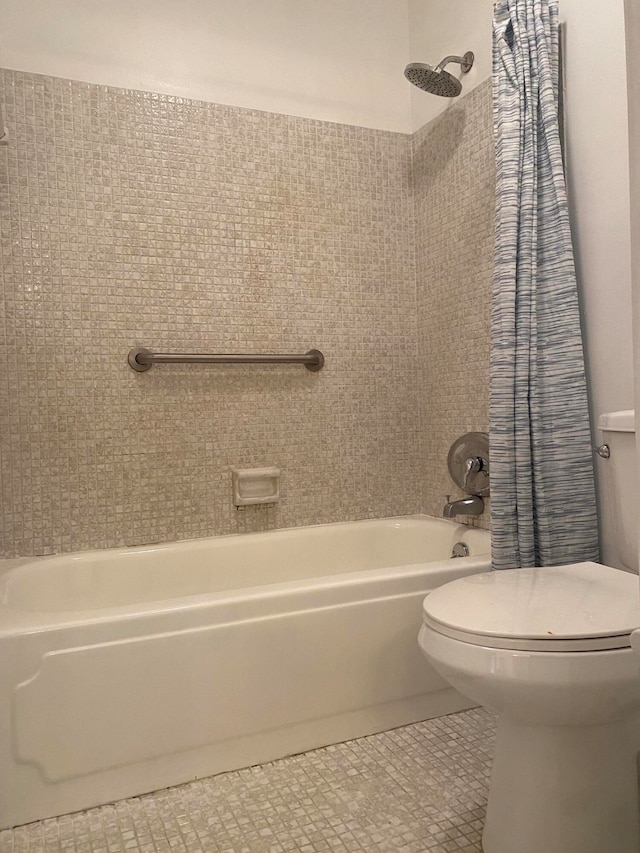 bathroom featuring shower / bath combo with shower curtain, toilet, and tile patterned floors