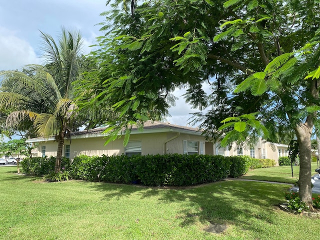 view of home's exterior with a yard