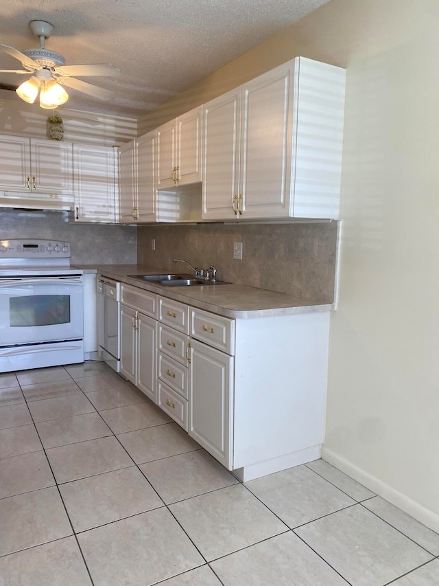 kitchen featuring white appliances, sink, a textured ceiling, and ceiling fan