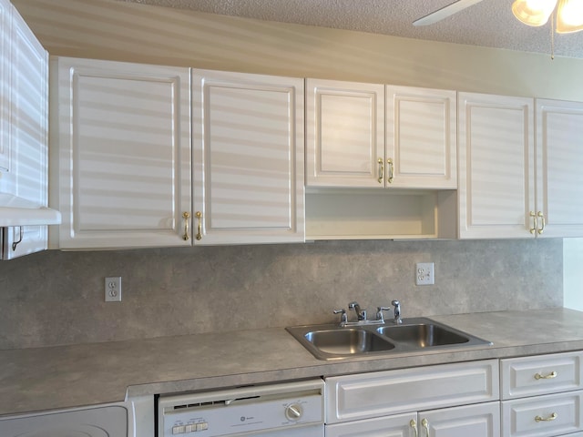 kitchen with white dishwasher, ceiling fan, sink, and white cabinets