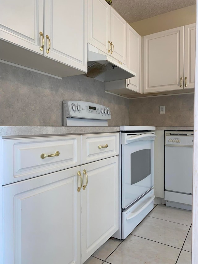 kitchen featuring white cabinetry, white appliances, light tile patterned flooring, and a textured ceiling