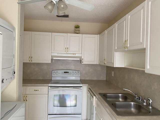 kitchen with stacked washing maching and dryer, ceiling fan, white range with electric cooktop, and white cabinets