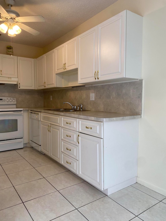 kitchen featuring ceiling fan, sink, white appliances, and white cabinetry