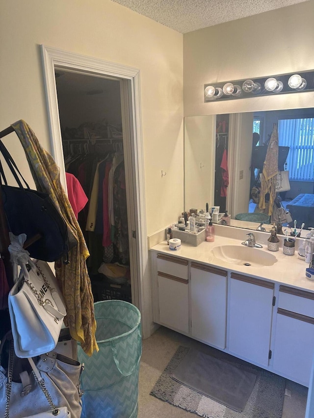 bathroom featuring a textured ceiling and vanity