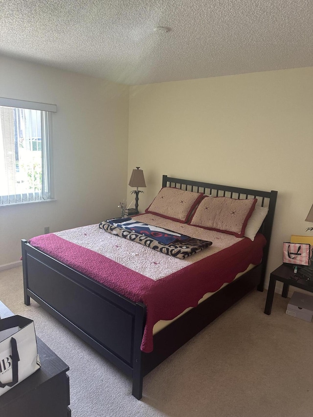 carpeted bedroom featuring a textured ceiling