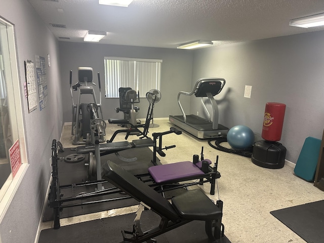 exercise room with a textured ceiling