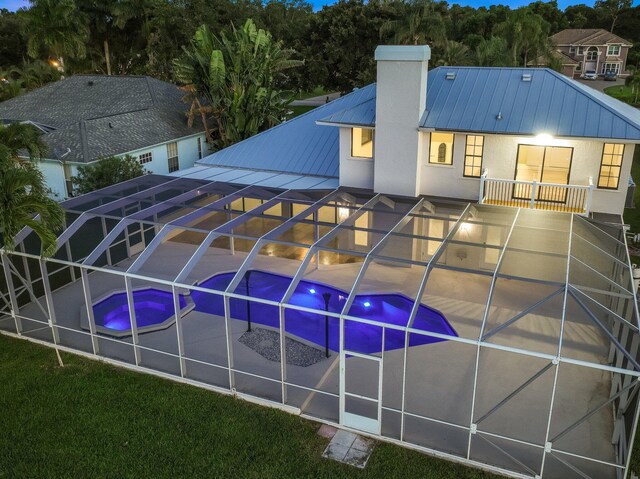 view of pool with glass enclosure